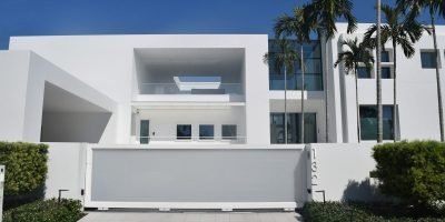 white concrete building with green plants on the side